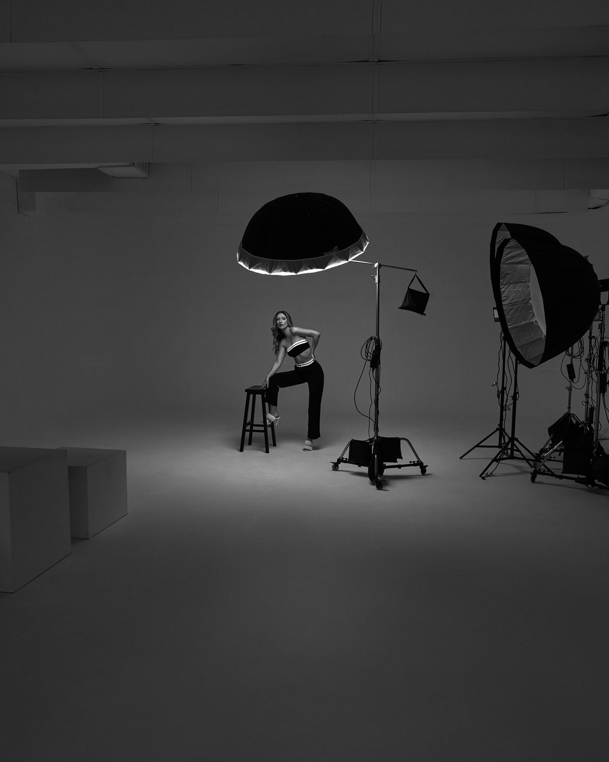 Model Hannah on a studio set with lighting equipment during a black and white test shoot in Dallas, Texas